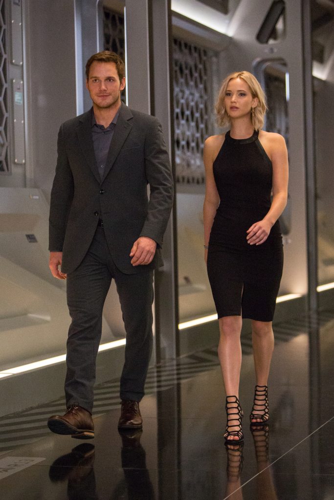 Jim (CHRIS PRATT) and Aurora (JENNIFER LAWRENCE) walk thru the Hibernation Bay on date night in Columbia Pictures' PASSENGERS.